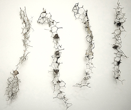 four sculptures of paper pulp, chicken wire, water chestnuts and other scraps